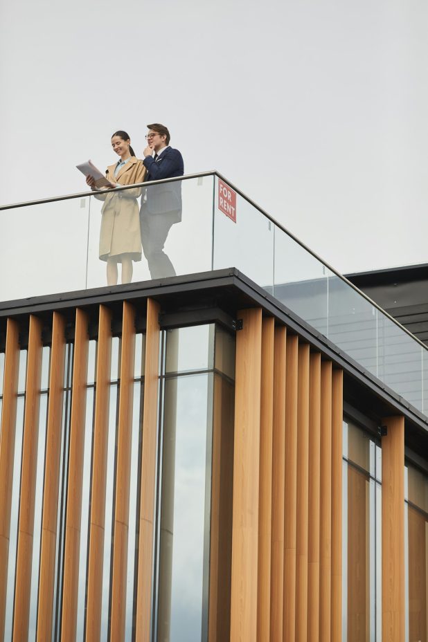 Two Real Estate Agents Standing on Roof